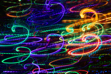 Abstract glowing multicolored swirls on black background. 