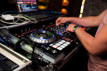 Fototapeta na wymiar DJ plays music in the club