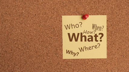 Sticky note with question on cork bulletin board