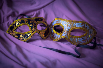 embroireded masks with purple curtain for carnival background