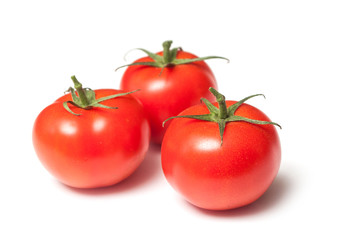 closeup of fresh tomatoes on white background