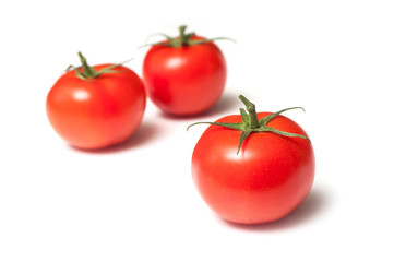 closeup of fresh tomatoes on white background