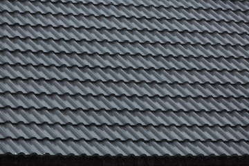 rain storm downpour on black roof tile of residential house