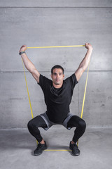 Personal instructor performing exercise with fitness band