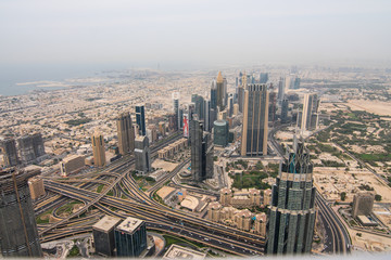 Fototapeta na wymiar DUBAI, UAE - October, 2018: Top view of Dubai urban skyline from Burj Khalifa. Dubai city view from the top of Burj Khalifa