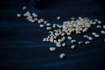 Dried black-eyed beans on the black stone background