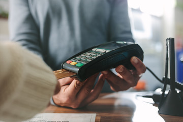Customer paying by credit card at drug store