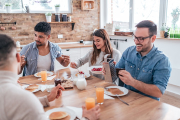 Food party. Friends eating homemade pancakes.