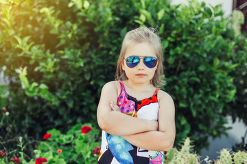 Fashionable outdoor portrait of preschooler gilr in sun glasses. Summer, childhood, vacation concept