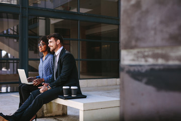 Business colleagues sitting at office hallway