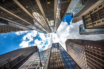 Fototapeta na wymiar Architectural View of Modern Glass Skyscrapers. Building Against Blue Sky, Manhattan, New York City, New York, USA