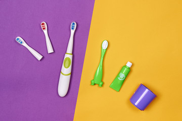 Baby smart electric toothbrush. Modern technology for health. Healthy teeth. Dentistry. Medical robot. Purple and yellow paper background