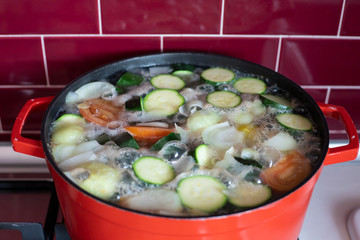Red pot with boiling soup.