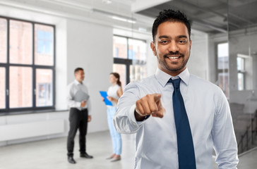 business, realty and hiring concept - smiling indian businessman or realtor pointing to you over...