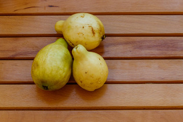 Whole guava fruits on wooden table