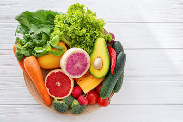 Fresh ingredients for vegetable salad on wooden table. Diet food