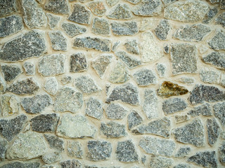 Detail of grey stone wall. Close up view on rock wall surface. Abstract background. Stone wall texture. Grey block pattern