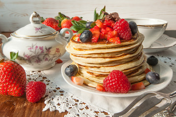 Strawberry chocolate pancakes on a vintage table