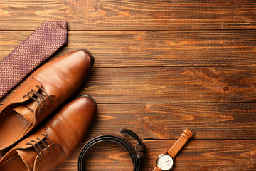 Stylish male accessories on wooden background
