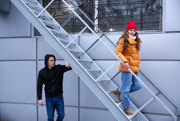 Male thief going to attack young woman outdoors