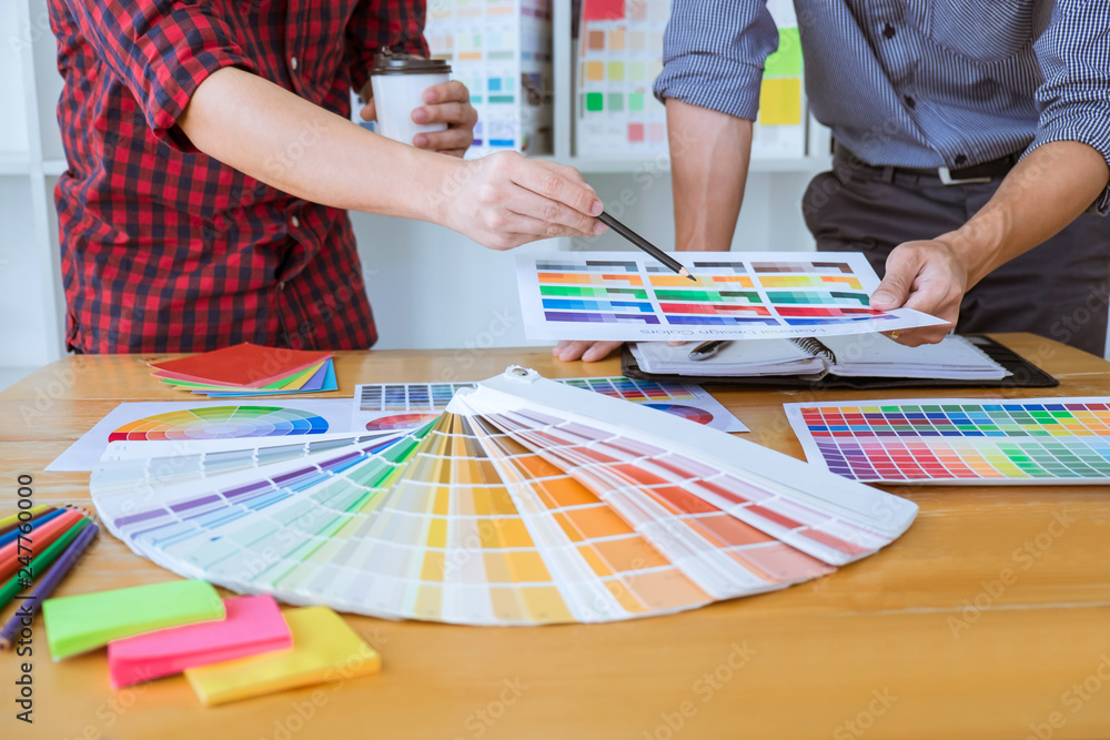 Poster teamwork of young creative designers working on project together and choose color swatch samples for