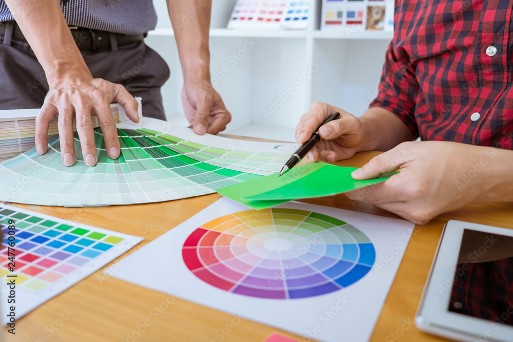 Poster teamwork of young creative designers working on project together and choose color swatch samples for