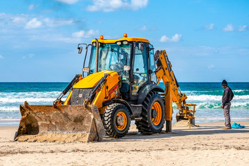 15/12/2018 Israel, Netanya, the driver of the excavator runs a bucket of manipulator, performs the...