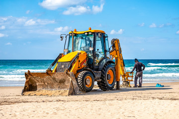 15/12/2018 Israel, Netanya, the driver of the excavator runs a bucket of manipulator, performs the...