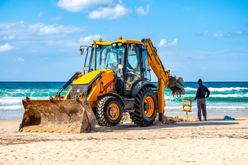 15/12/2018 Israel, Netanya, the driver of the excavator runs a bucket of manipulator, performs the...