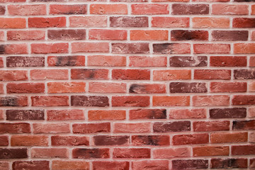 Beautiful new brick wall, texture of red stone blocks close up