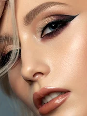 Wanddecoratie Schoonheidssalon Portrait of young beautiful woman with evening make up. Modern fashion eyeliner wing. Studio shot. Extreme closeup, partial face view  © Liudmila Dutko