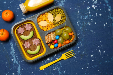 Lunch box with tasty creative food for kid on color background