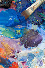Fototapeta premium Artists oil paints and brush multi coloured close up semi abstract