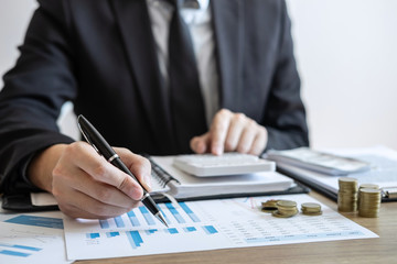 Businessman accountant counting money and making notes at report doing finances and calculate about cost of investment and analyzing financial data, Financing Accounting Banking Concept