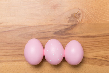 pink Easter eggs on wooden background