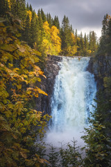 Fototapeta na wymiar Big waterfalls in the forest. Autumnal landscape from Norway.