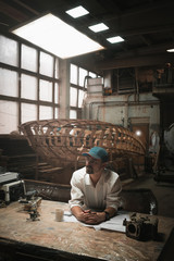 Fototapeta na wymiar boat construction engineer at work. dreaming.