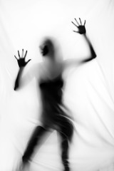 Silhouette of beautiful sexy woman behind curtain on white background