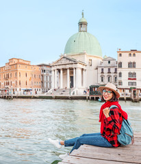 Fototapeta na wymiar Happy asian woman travels in Venice. Great View on the famous tourist landmark Grand canal. Italy vacation concept