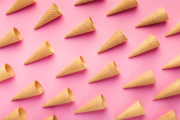 Empty wafer ice cream cones on pink background