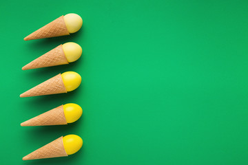 Bright creative Easter background with eggs in waffle cones