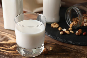 Glass of fresh milk on wooden table