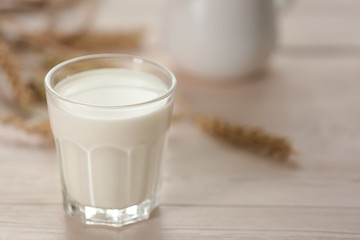 Glass of fresh milk on light table