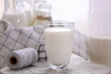 Glass of fresh milk on light table