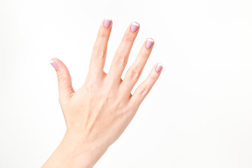 Closeup view of female hand. Woman shows 5 fingers, open palm, stop gesture. Horizontal color photography.