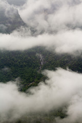 fog in the mountains and a beautiful waterfall