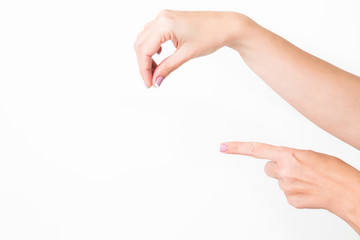 Closeup view of female hands holding nothing isolated on white background. WOman pointing at...