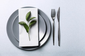 Beautiful table setting with floral decor on light background