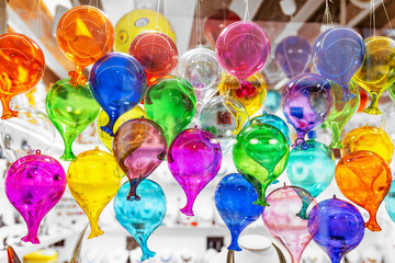 Colorful decorated objects made of a famous murano glass in a shop window in Venice
