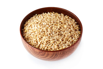 Barley grain (Hordeum vulgare) in wooden bowl isolated on white background